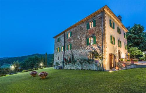 a large stone building on a grass field at Luxurious Home In Monterchi in Monterchi