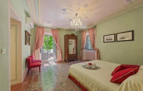 a bedroom with a bed and a chandelier at Luxurious Home In Monterchi in Monterchi