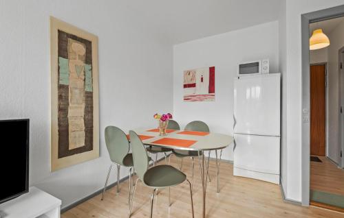 a kitchen with a table and chairs and a refrigerator at Nice Apartment In Esbjerg With Wifi in Esbjerg