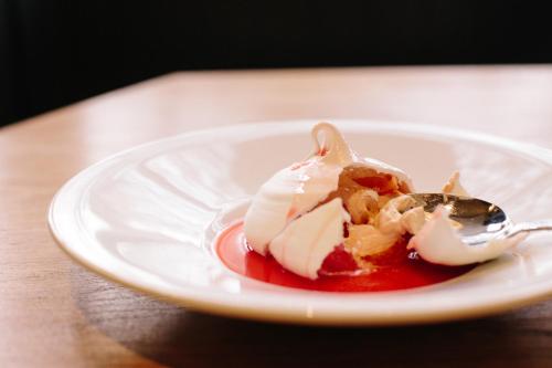 a white plate with a dessert on a spoon at The Redan Inn in Chilcompton