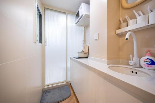 a bathroom with a sink and a shower at Tonight Homestay Jing'an Temple Branch Shanghai in Shanghai