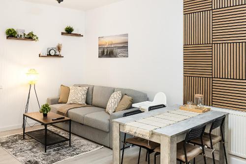 a living room with a couch and a table at Nordic Comfort Apartments in Bremerhaven