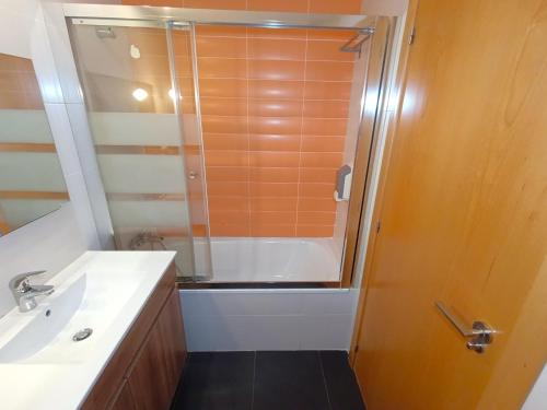 a bathroom with a shower and a sink at Apartamentos Marina Suites in Grao de Castellón
