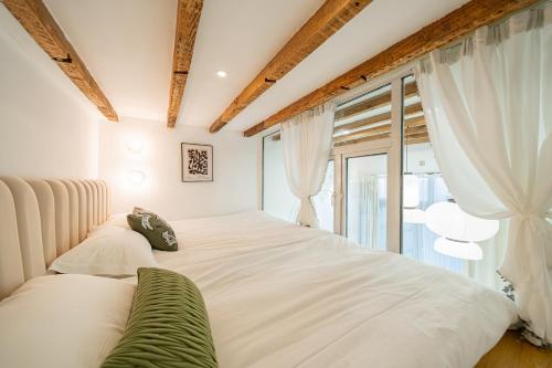 a bedroom with a large white bed and a window at Tonight Homestay Jing'an Temple Branch Shanghai in Shanghai