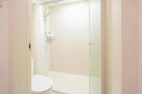 a bathroom with a toilet and a shower at Tonight Homestay Jing'an Temple Branch Shanghai in Shanghai