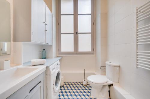 une salle de bain blanche avec des toilettes et un lavabo dans l'établissement MDOR Le Nid Bleu - Au coeur de Bordeaux, à Bordeaux