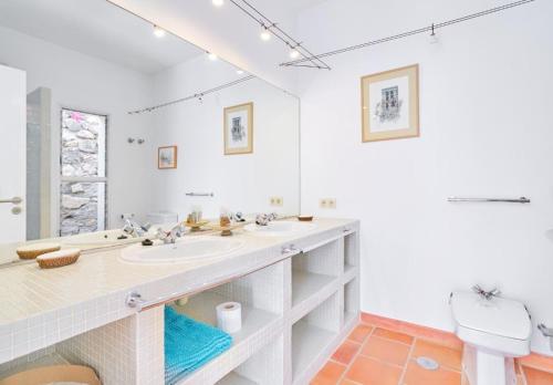a white bathroom with a sink and a toilet at Only Adult Villa El Abanico in Almuñécar
