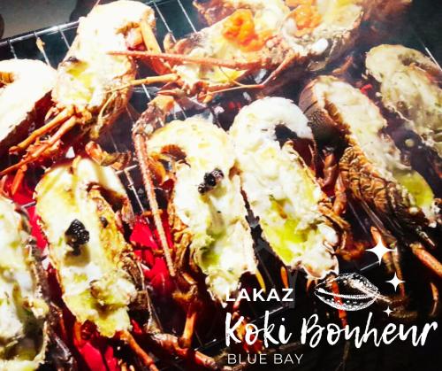a plate of food with seafood on a plate at Lakaz Koki Bonheur Blue Bay in Blue Bay