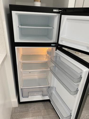 an empty refrigerator with its door open in a kitchen at Newly renovated studio close to the beach in Hollywood