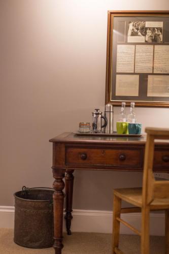 a wooden table with a coffee maker on top of it at The Redan Inn in Chilcompton