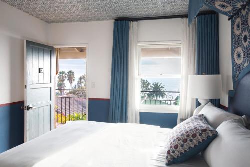 a bedroom with a bed and a window with a view at Casa Laguna Hotel & Spa in Laguna Beach