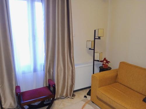 a living room with a couch and a window at Μονοκατοικία μέσα στα έλατα in Lávka