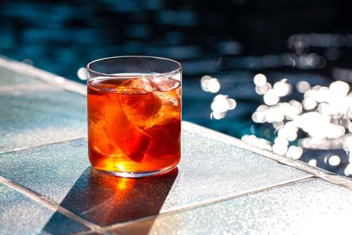 a glass of tea sitting on top of a table at Radisson Blu 1882 Hotel, Barcelona Sagrada Familia in Barcelona