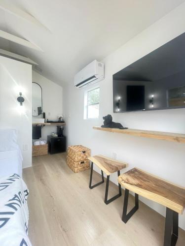 a room with a bed and two benches in it at Charming Coastal Retreat in Miami