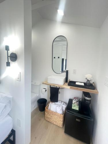a bathroom with a sink and a mirror on a wall at Charming Coastal Retreat in Miami