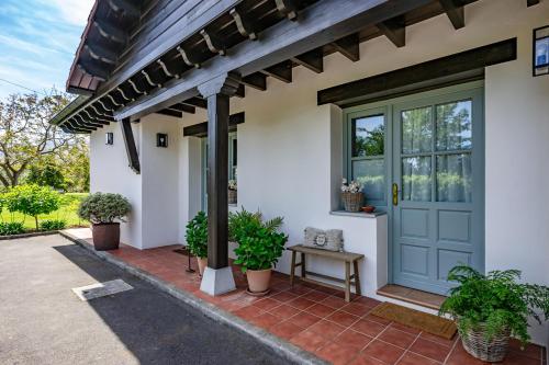 a front door of a house with potted plants at Entrenueces appto2 camango in Camango