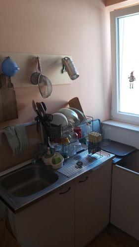 a kitchen counter with a sink and a window at Вила Драгоман in Dragoman