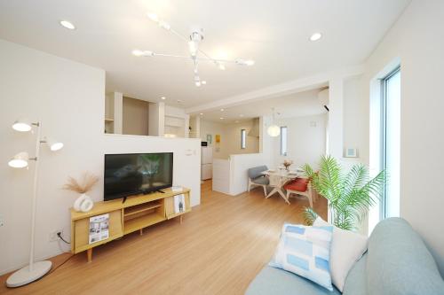 a living room with a couch and a tv in it at Near Skytree 90sqm 4BDR! 4mins to station! in Tokyo
