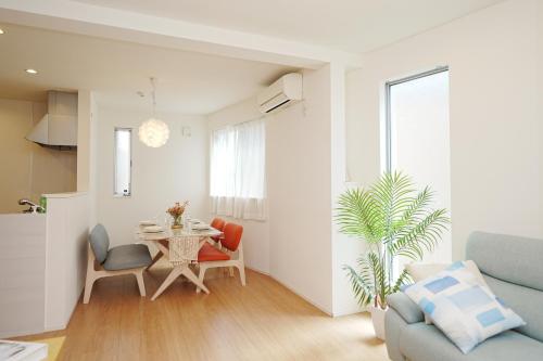 a living room with a table and chairs at Near Skytree 90sqm 4BDR! 4mins to station! in Tokyo