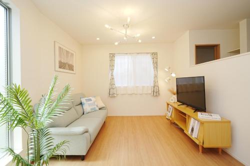 a living room with a couch and a tv at Near Skytree 90sqm 4BDR! 4mins to station! in Tokyo