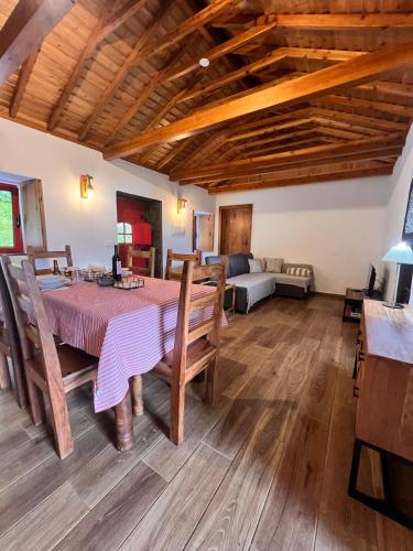 a dining room with a table and a couch at Casa do Postigo Rustic Refuge to Relax in Angra do Heroísmo