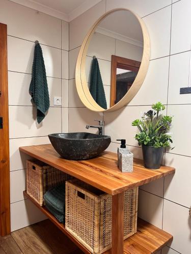 a bathroom with a sink and a mirror at Casa do Postigo Rustic Refuge to Relax in Angra do Heroísmo
