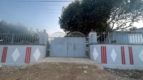 a gate in front of a gate with a fence at Chitwan Comforts Apt 2 in Nārāyangarh