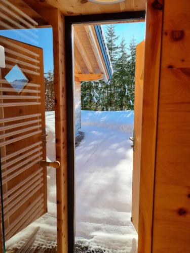 a door to the outside of a house in the snow at Alpenflair-Chalets-Balderschwang in Balderschwang