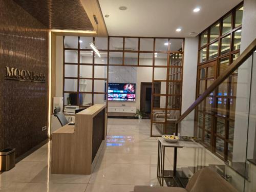 a lobby of a building with a tv in it at MoonBasa Boutique Hotel and Spa Infopark , Kakkanad in Cochin