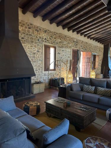 a living room with a couch and a fireplace at Finca El Corchito Aracena in Aracena