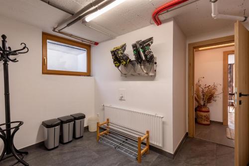 a waiting room with trash cans and a window at Haus Kaufmann in Ellmau