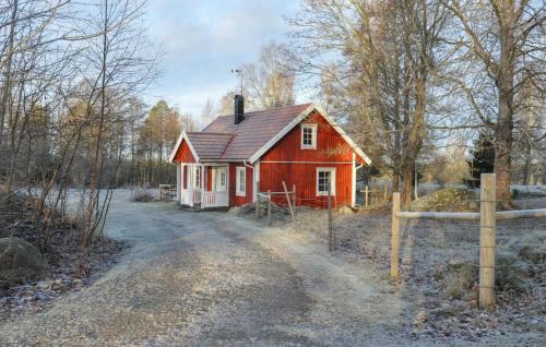 a small red house on the side of a dirt road at 3 Bedroom Pet Friendly Home In Tived in Tived