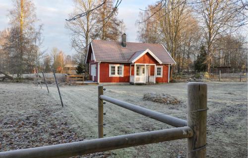 a small red house in a field with a fence at 3 Bedroom Pet Friendly Home In Tived in Tived