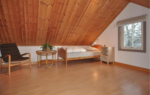 a bedroom with a bed and a table and a chair at 3 Bedroom Pet Friendly Home In Tived in Tived