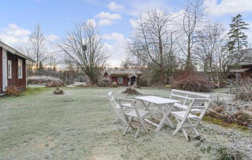a white table and chairs in a yard at 4 Bedroom Nice Home In Tived in Tived