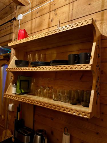 a wooden shelf with pots and pans on it at Apartamenty u Gąsiorów in Biały Dunajec