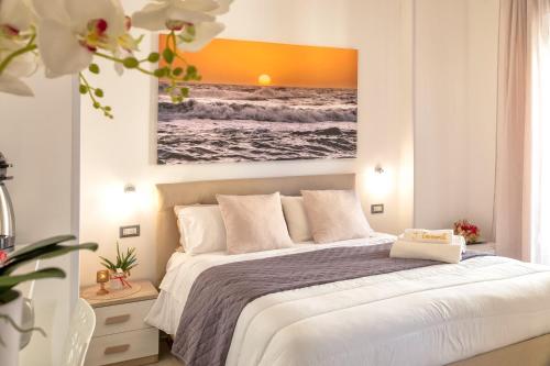 a bedroom with a bed and a painting on the wall at I Tramonti in Alghero