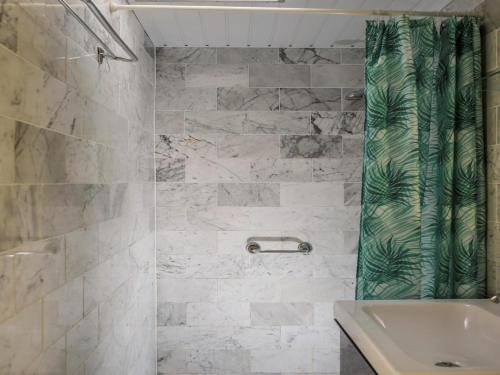 a bathroom with a shower and a sink at Family bungalow with garden in Sint Maartenszee