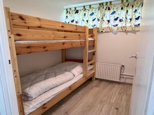 a bunk bed in a room with a bunk bed in a room at Pet-friendly bungalow near Beach in Sint Maartenszee
