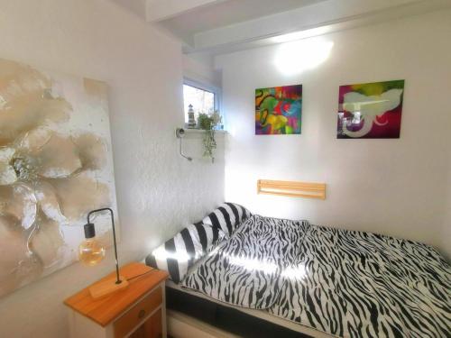 a zebra themed room with a bed and a lamp at Inviting bungalow with private garden in Sint Maartenszee