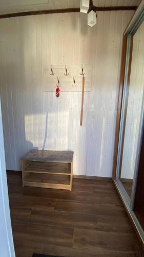 a room with a shelf and a bench on a wall at Five House in Skhidnitsa