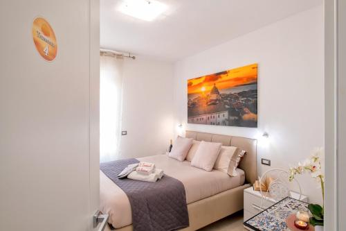 a bedroom with a bed and a painting on the wall at I Tramonti in Alghero