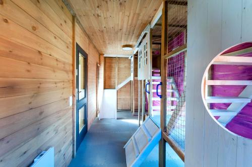 a room with wooden walls and stairs in a tiny house at SOBIESZEPTY Odetchnij ciszą in Gdańsk