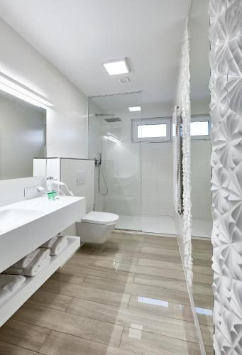 a bathroom with a toilet and a sink and a shower at Hotel Maria in Dębno Polskie