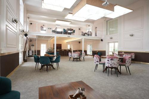 a large room with tables and chairs in it at Astroport Sariska Treetop by Eight Continents in Tehla