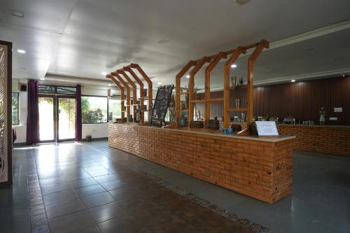 a restaurant with a brick counter in a building at Astroport Sariska Treetop by Eight Continents in Tehla