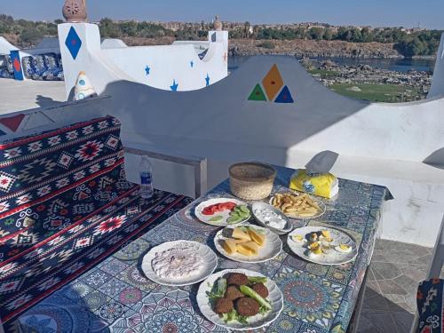 a table with plates of food on top of a ramp at Nubian Kulih house in Aswan