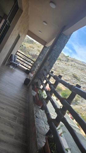 a view from the top of a building with a window at Roghan Hospitality Inn in Al Ḩamrāʼ