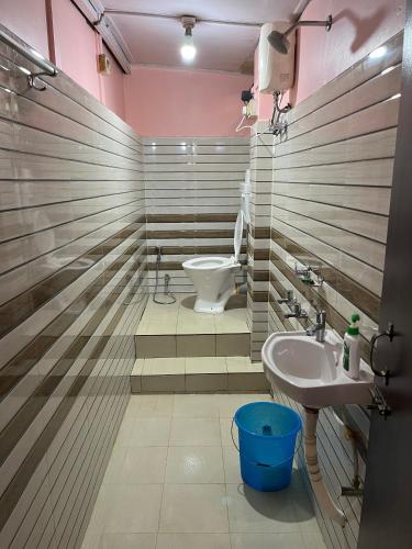 a bathroom with a toilet and a sink at Hemalata Heritage Home in Guwahati