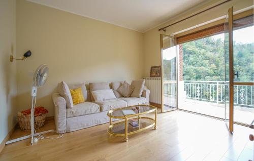 a living room with a couch and a glass table at 3 Bedroom Nice Home In Molini Di Triora in Molini di Triora